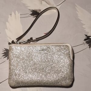 This is a Coach Bleecker metallic crackle canvas wristlet, also described as a s